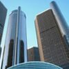 A striking view of Detroit's Renaissance Center skyscrapers with blue sky backdrop.